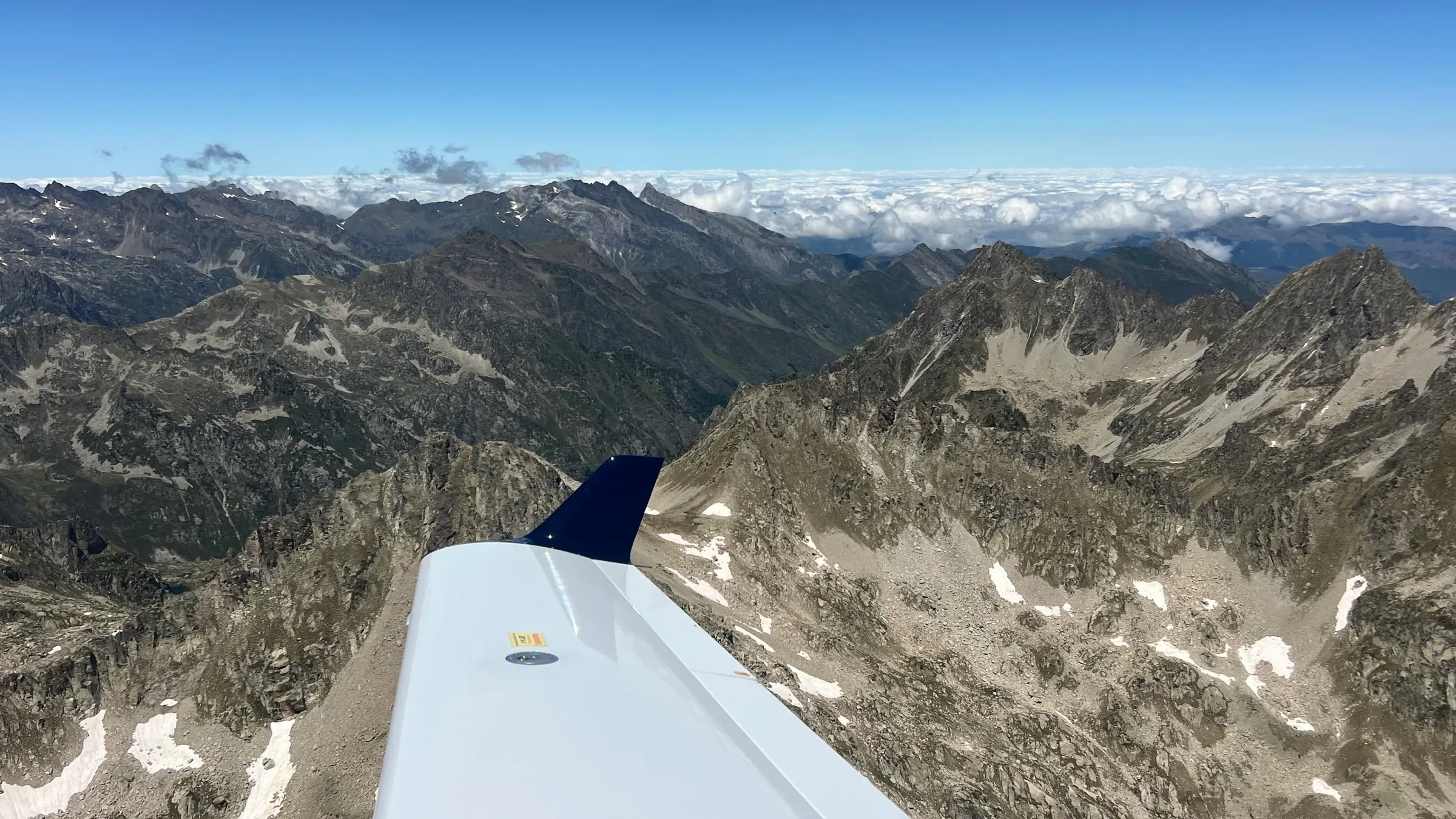 Diamond DA40 wingtip over the rocky peaks of the Pyrenees
